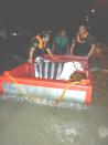 PAWS rescuers were able to borrow a wooden boat to transport the rescued dogs.