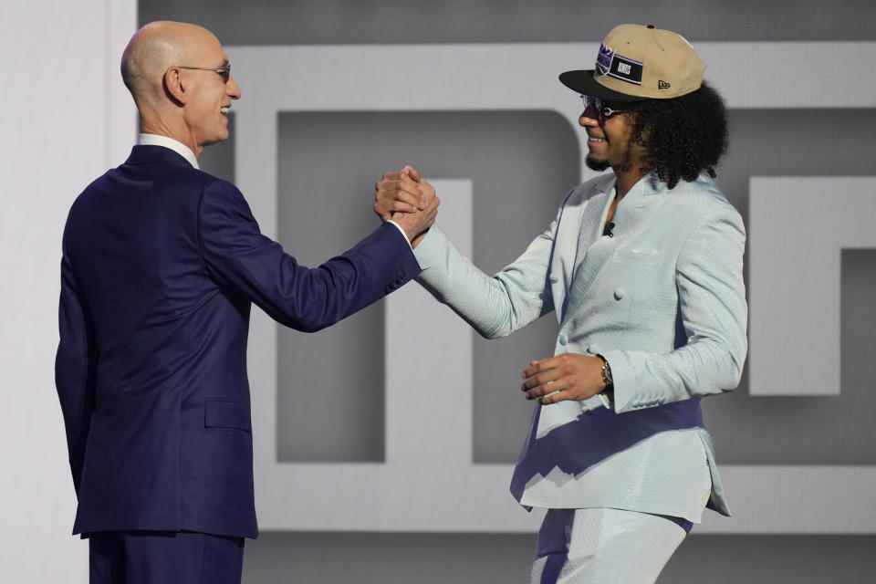 Devin Carter, right, greets NBA commissioner Adam Silver after being selected by the Sacramento Kings as the 13th pick during the first round of the NBA basketball draft, Wednesday, June 26, 2024, in New York. (AP Photo/Julia Nikhinson)