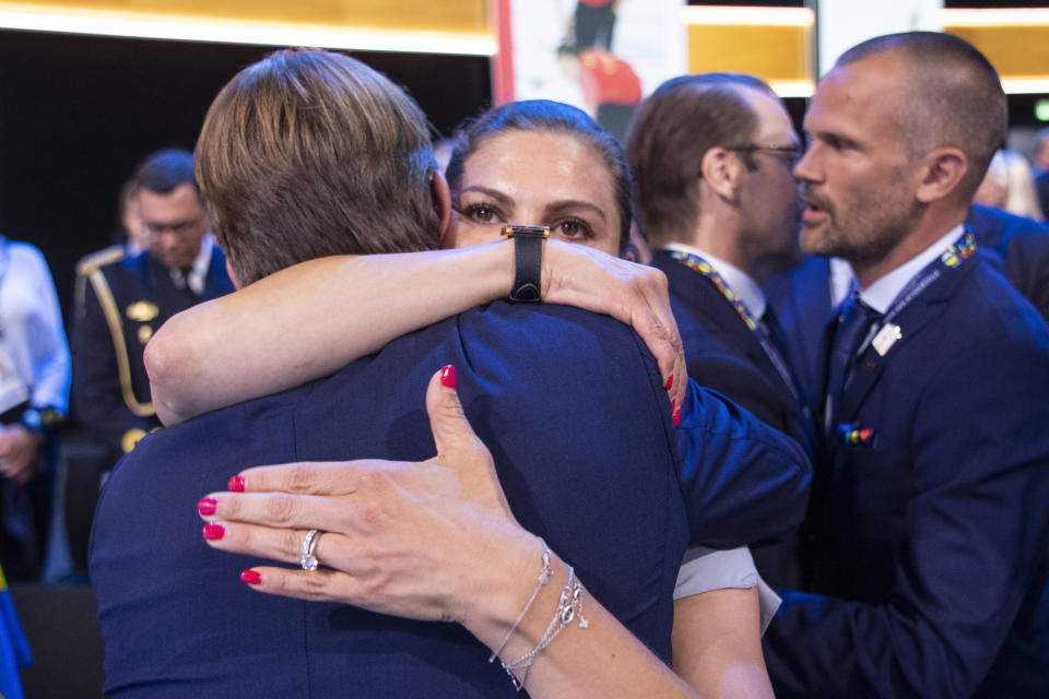 FILE - Crown Princess Victoria from Sweden, member of the candidate for the Olympic Winter Games 2026 Stockholm-Are delegation, hugs Sweden's Olympic Committee President Mats Arjes, left, as International Olympic Committee (IOC) president Thomas Bach from Germany announces that Milan-Cortina has won the bid to host the 2026 Winter Olympic Games, during the first day of the 134th Session of the International Olympic Committee (IOC), at the SwissTech Convention Centre, in Lausanne, on June 24, 2019. (Jean-Christophe Bott/Keystone via AP, File)