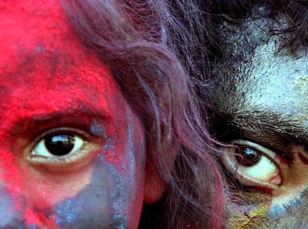 Indian kids smeared with colors look on as they celebrate 'Holi,' the Indian festival of colors, in Calcutta, India, Sunday, Feb. 28, 2010. The festival also marks the coming of spring. (AP Photo/Sucheta Das)