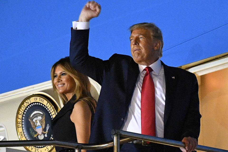 Donald Trump raises his fist as he and US First Lady Melania Trump board Air Force One to depart Nashville International Airport after the final presidential debate in Nashville, Tennessee, on October 22, 2020. (Photo by MANDEL NGAN / AFP via Getty Images)