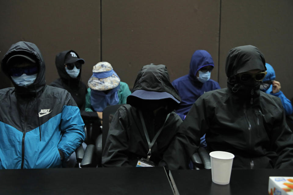 Relatives of 12 Hong Kong activists detained at sea by Chinese authorities attend a press conference in Hong Kong, Saturday, Sept. 12, 2020. They called for their family members to be returned to the territory, saying their legal rights were being violated. (AP Photo/Kin Cheung)