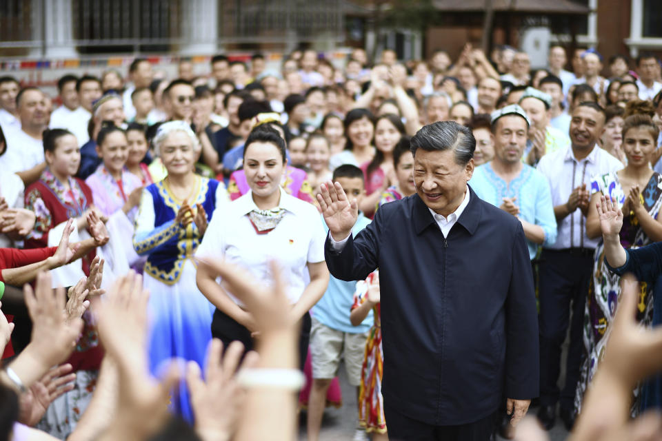 In this photo released by China's Xinhua News Agency, Chinese President Xi Jinping, center, visits the community of Guyuanxiang in the Tianshan District in Urumqi in northwestern China's Xinjiang Uyghur Autonomous Region, Wednesday, July 13, 2022. (Yan Yan/Xinhua via AP)