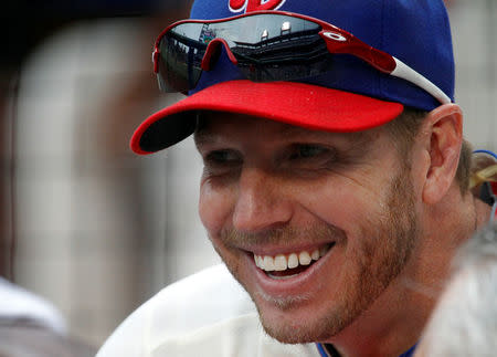 FILE PHOTO: Philadelphia Phillies starting pitcher Roy Halladay smiles while sitting in the dugout before their MLB National League baseball game against the Chicago Cubs in Philadelphia, Pennsylvania, U.S., June 11, 2011. REUTERS/Tim Shaffer/File Photo