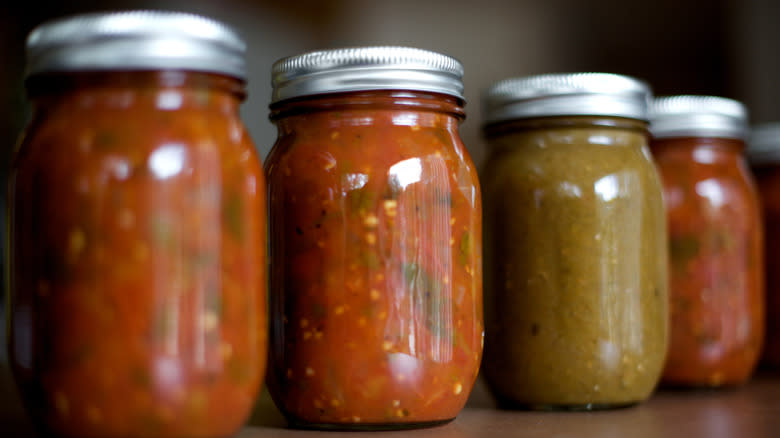 red and green salsas in jars