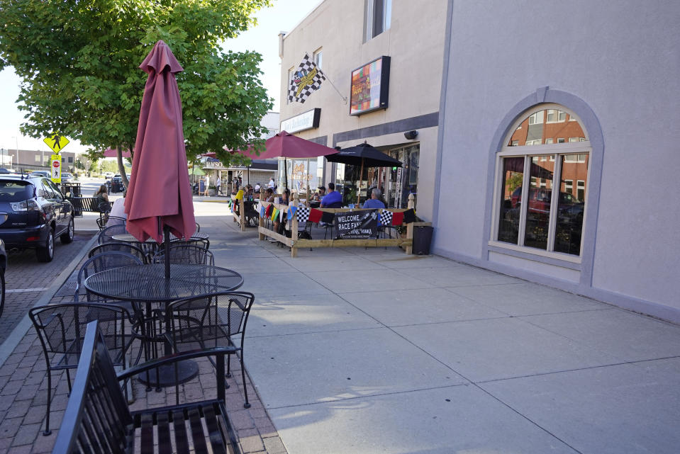 Guest have a meal outside of a restaurant not far from the Indianapolis Motor Speedway, Thursday, Aug. 20, 2020, in Indianapolis. (AP Photo/Darron Cummings)