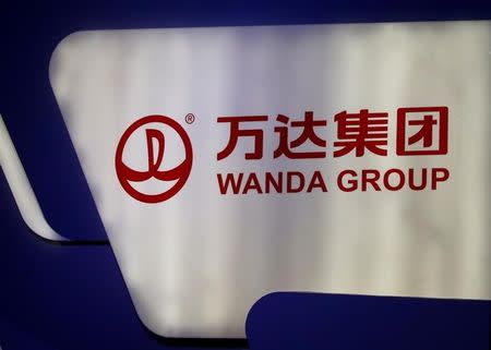 FILE PHOTO: A logo of Wanda Group is seen at a Wanda Group and China Union Pay joint news conference in Beijing, China, March 2, 2017. REUTERS/Thomas Peter/File Photo