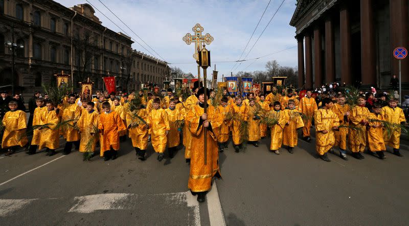 FILE PHOTO: Children take part in a religious procession to mark Palm Sunday in St. Petersburg