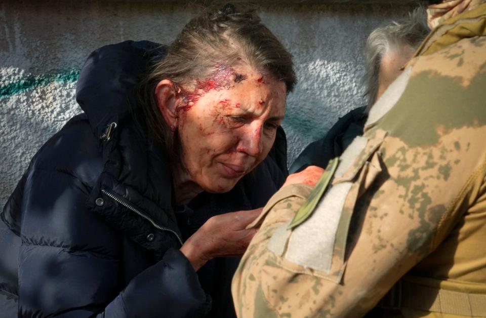 An injured woman reacts after Russian shelling in Kyiv (Copyright 2022 The Associated Press. All rights reserved)