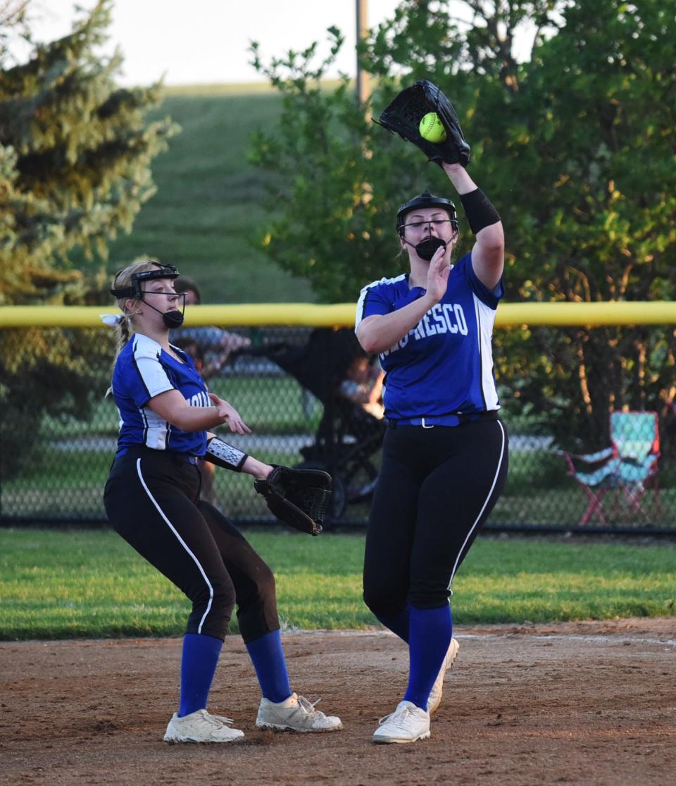 Colo-NESCO first baseman Riley Handsaker catches a fly ball in front of Royal second baseman Katherine Rouse during her team's 7-0 loss to Collins-Maxwell in the 1A Region 5 quarterfinal game at Collins Wednesday.