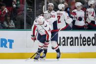 Washington Capitals defenseman John Carlson (74) and right wing Tom Wilson (43) celebrate after a goal scored by Carlson in the first period of an NHL hockey game in Dallas, Friday, Jan. 28, 2022. Wilson also scored in the same period. (AP Photo/Tony Gutierrez)