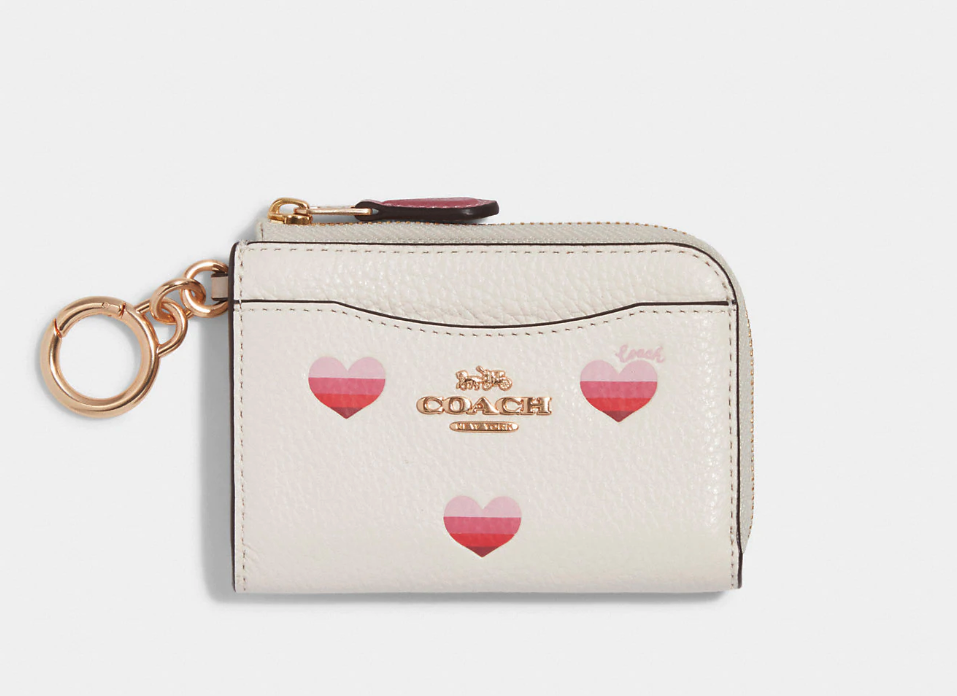 L Zip Card Case With Stripe Heart Print. Image via Coach Outlet.