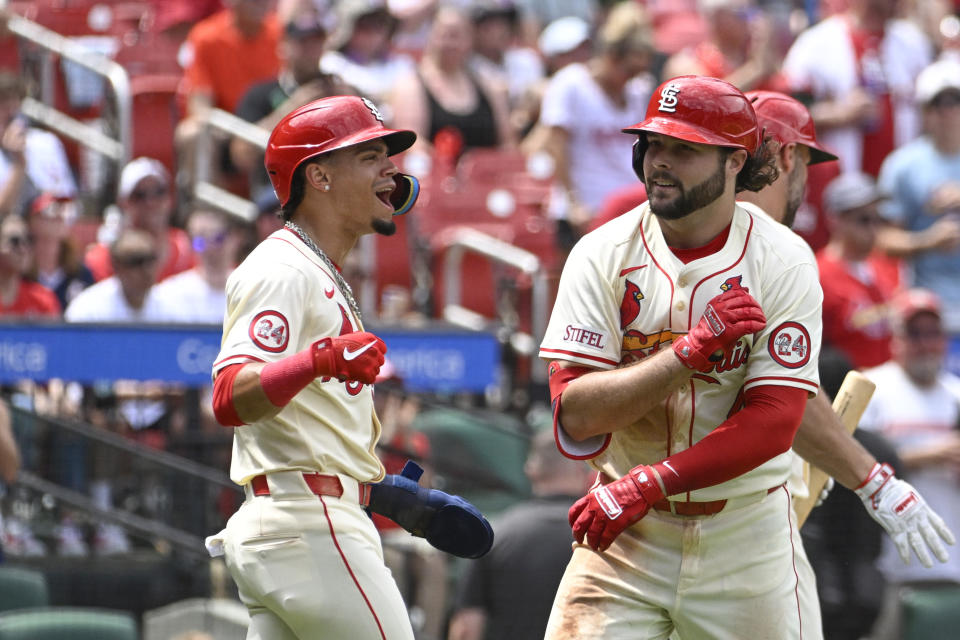 St. Louis Cardinals' Alec Burleson, right, is congratulated by teammate Masyn Winn, left, after hitting a three-run home run in the fourth inning of a baseball game against the San Francisco Giants, Saturday June 22, 2024, in St. Louis. (AP Photo/Joe Puetz)