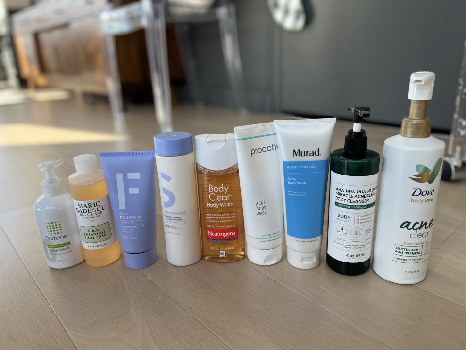 some of the acne body washes that we tested for our review lines up on the floor