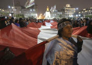 In this Sept. 18, 2018 photo, demonstrators shout slogans against lawmakers, as they march in support of a referendum on anti-corruption measures, proposed by President Martin Vizcarra, at San Martin plaza in Lima, Peru. Vizcarra is pushing forward a referendum on Dec. 9 aimed at preventing abuse of power following a series of corruption scandals that ended the careers of some of the nation's highest profile judges and politicians. (AP Photo/Martin Mejia)