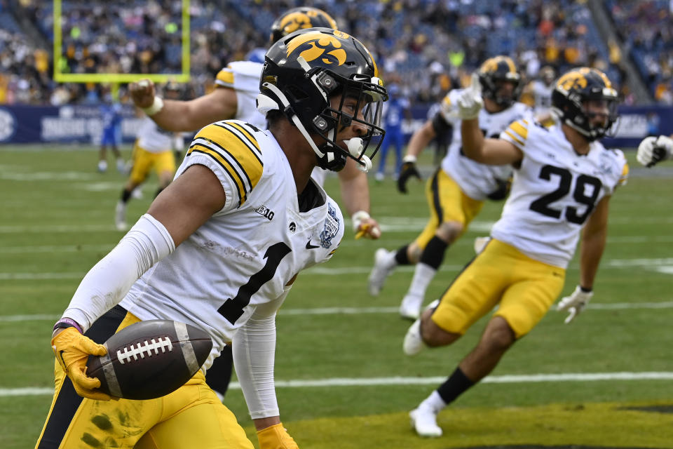 Iowa defensive back Xavier Nwankpa (1) scores a touchdown after intercepting pass against Kentucky in the first half of the Music City Bowl NCAA college football game Saturday, Dec. 31, 2022, in Nashville, Tenn. (AP Photo/Mark Zaleski)