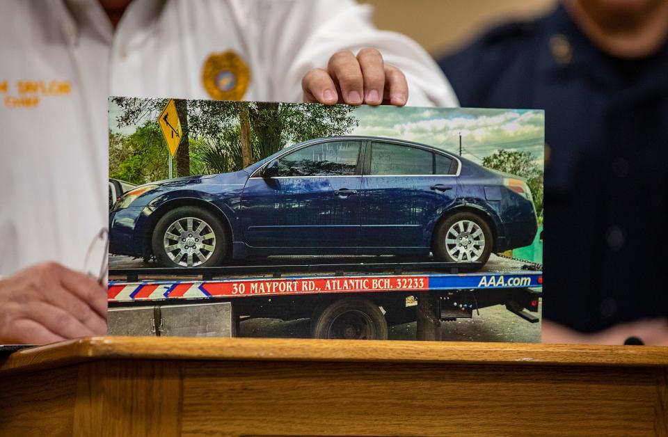 Lakeland Police Chief Sam Taylor holds a photo of a dark blue Nissan that was recovered a day after the shooting on Iowa Avenue.