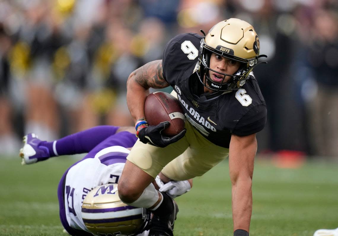 Colorado wide receiver Daniel Arias, front, is tripped by Washington defensive back Trent McDuffie during the first half of an NCAA college football game Saturday, Nov. 20, 2021, in Boulder, Colo. (AP Photo/David Zalubowski)