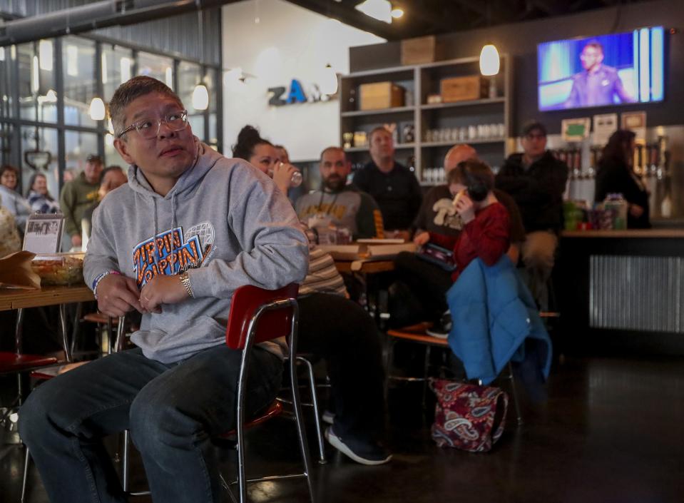 Along with fans and supporters, Ben Chan watches himself in Game 6 of the "Jeopardy!" Tournament of Champions Tuesday at Zambaldi Beer in Allouez. He won $100,000 for placing second.