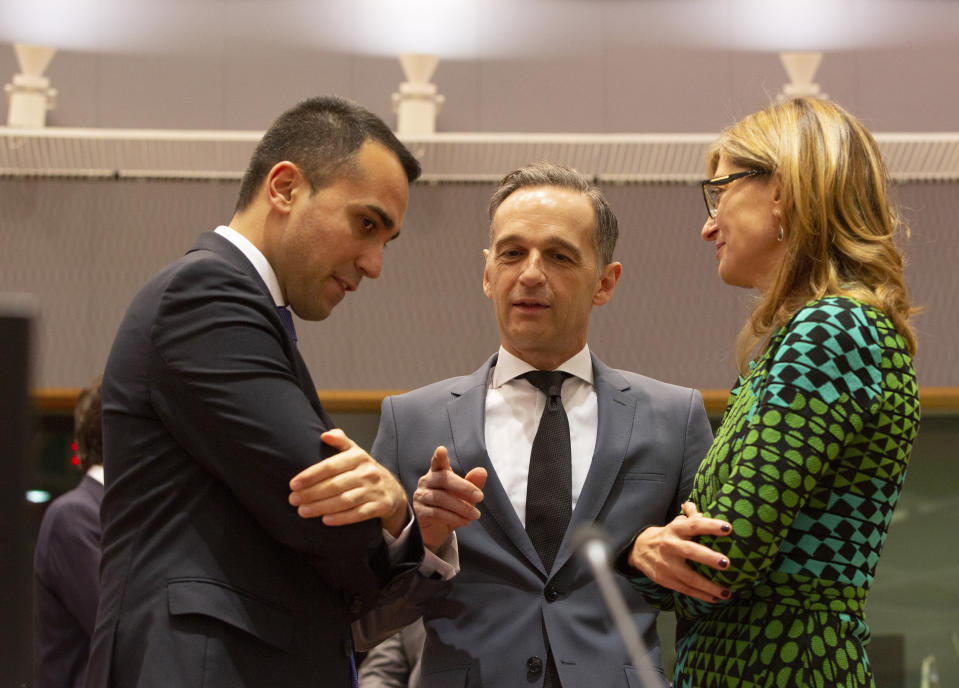 Italian Foreign Minister Luigi Di Maio, left, speaks with German Foreign Minister Heiko Maas, center, and Bulgarian Foreign Minister Ekaterina Zharieva during a meeting of EU foreign ministers at the Europa building in Brussels, Monday, Dec. 9, 2019. European Union foreign ministers are debating how to respond to a controversial deal between Turkey and Libya that could give Ankara access to a contested economic zone across the Mediterranean Sea. (AP Photo/Virginia Mayo)