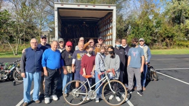 Members of the Newtown Rotary Club and Council Rock North High School Interact Club collect bicycles for Pedals for Progress during a donation drive Oct. 30 in Newtown.