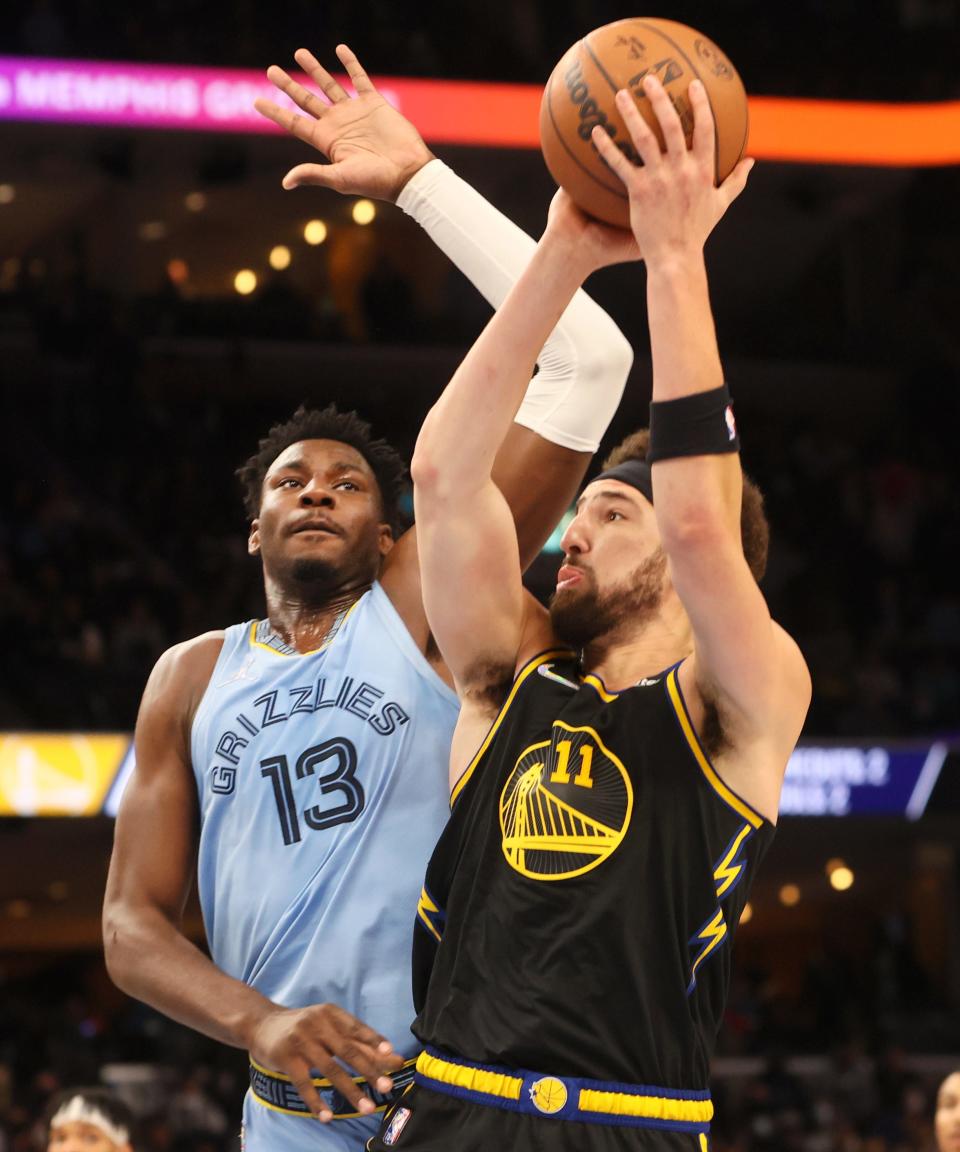 Memphis Grizzlies forward Jaren Jackson Jr. defends a shot by Golden State Warriors guard 	Klay Thompson at FedExForum on Tuesday, January 11, 2022.