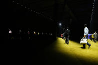 Models wear creations as part of the Prada men's Fall-Winter 2022-23 collection, unveiled during the Fashion Week in Milan, Italy, Sunday, Jan. 16, 2022. (AP Photo/Luca Bruno)