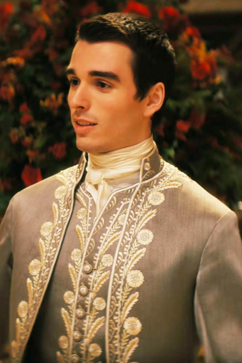 Corey Mylchreest, as King George, in a coat with intricate embroidered detailing