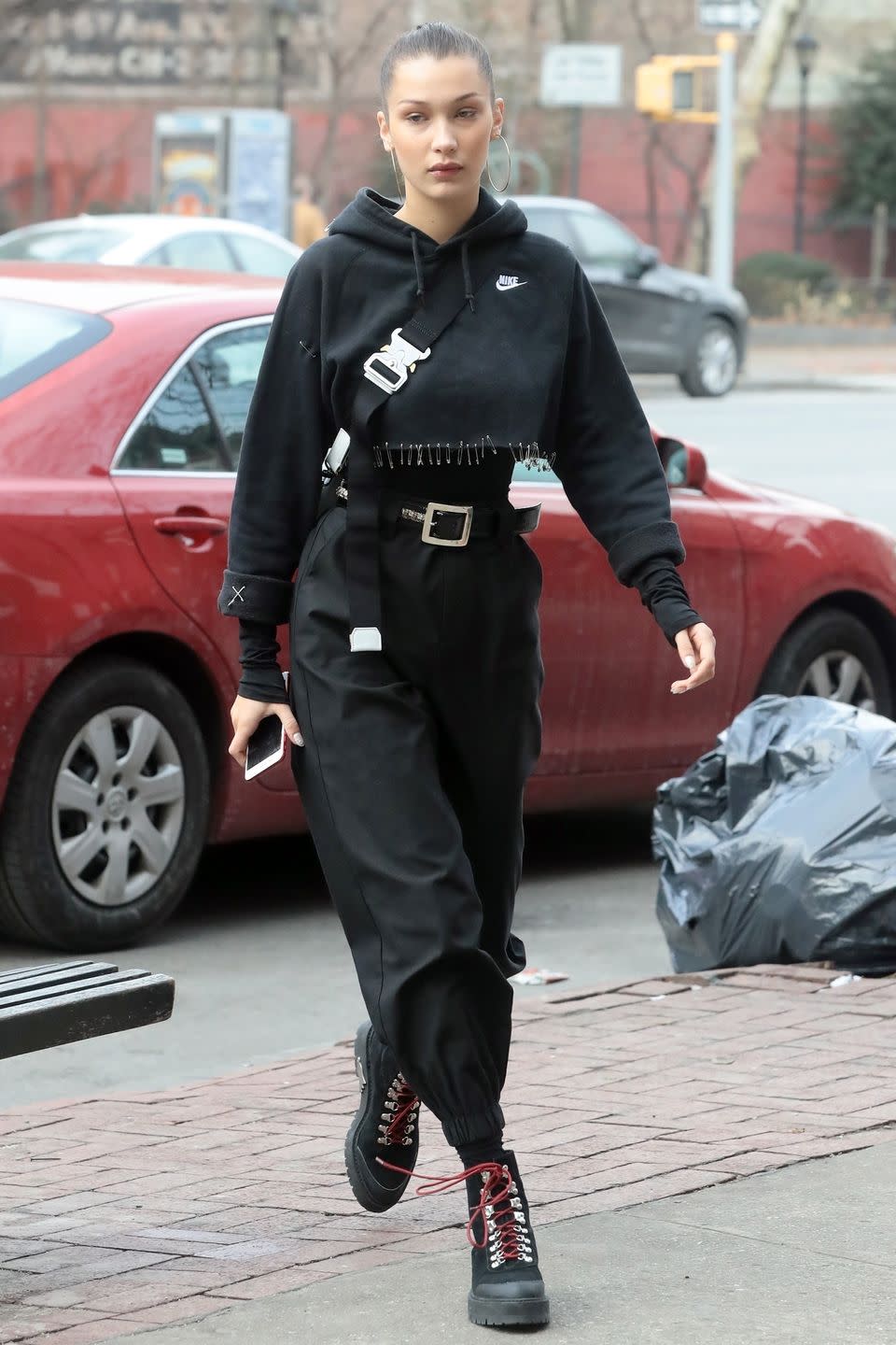 <p>In a cropped Nike sweater covered with a safety pin hem, black long sleeve shirt, high-waisted harem pants, and Off-White hiker boots while out in NYC.</p>