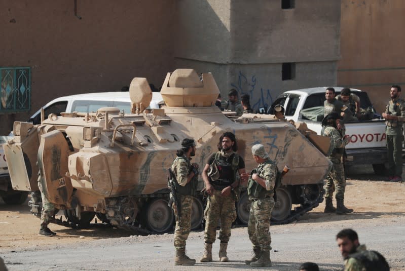 Turkey-backed Syrian rebel fighters gather near the border town of Tal Abyad