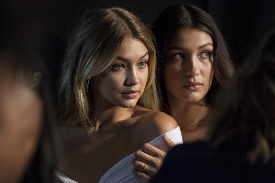 Models Gigi Hadid (L) and Bella Hadid pose for photos backstage before the Tommy Hilfiger Spring/Summer 2016 collection presentation during New York Fashion Week in New York, September 14, 2015. REUTERS/Andrew Kelly