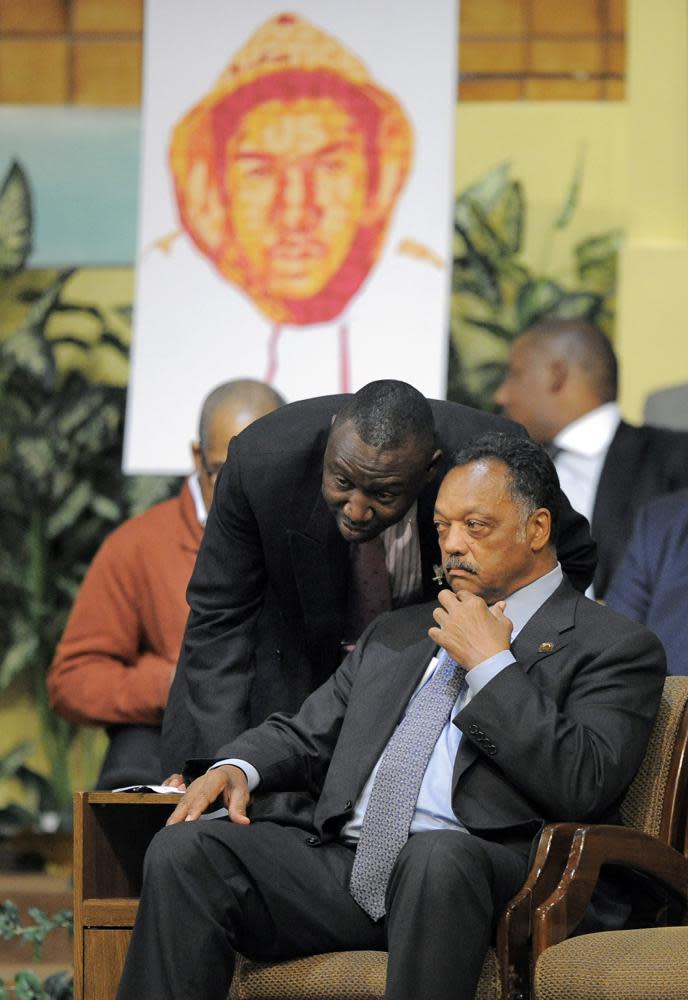 In this Thursday, April 26, 2012 file photo, Trayvon Martin family attorney Benjamin Crump, left, talks to Rev. Jesse Jackson during a rally in Los Angeles on behalf of the family of shooting victim Trayvon Martin. (AP Photo/Mark J. Terrill)