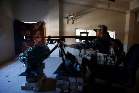 A sniper of the Iraqi federal police takes his position during clashes with Islamic State militants, in Mosul, Iraq March 25, 2017. Picture taken March 25, 2017. REUTERS/Khalid al Mousily