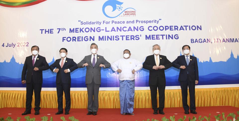 In this image provided by the Myanmar Ministry of Information, foreign ministers touch elbows during a group photo ahead of the Lancang-Mekong Cooperation group meeting in Bagan, Myanmar Monday, July 4. 2022. From left, Cambodian Foreign Minister Prak Sokhonn, Lao Foreign Minister Saleumxay Kommasith, Chinese Foreign Minister Wang Yi, Myanmar Foreign Minister Wunna Maung Lwin, Thailand Foreign Minister Don Pramudwinai and Vietnam Foreign Minister Bui Thanh Son. Myanmar’s military government hosted the first high-level regional meeting since the army took power last year with China’s foreign minister and his counterparts from Mekong Delta nations. (Myanmar Ministry of Information via AP)