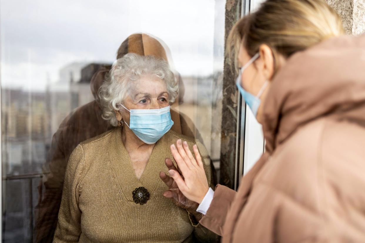   <span class="attribution"><a class="link " href="https://www.shutterstock.com/image-photo/woman-visiting-her-grandmother-isolation-during-1937823976" rel="nofollow noopener" target="_blank" data-ylk="slk:Shutterstock;elm:context_link;itc:0;sec:content-canvas">Shutterstock</a></span>