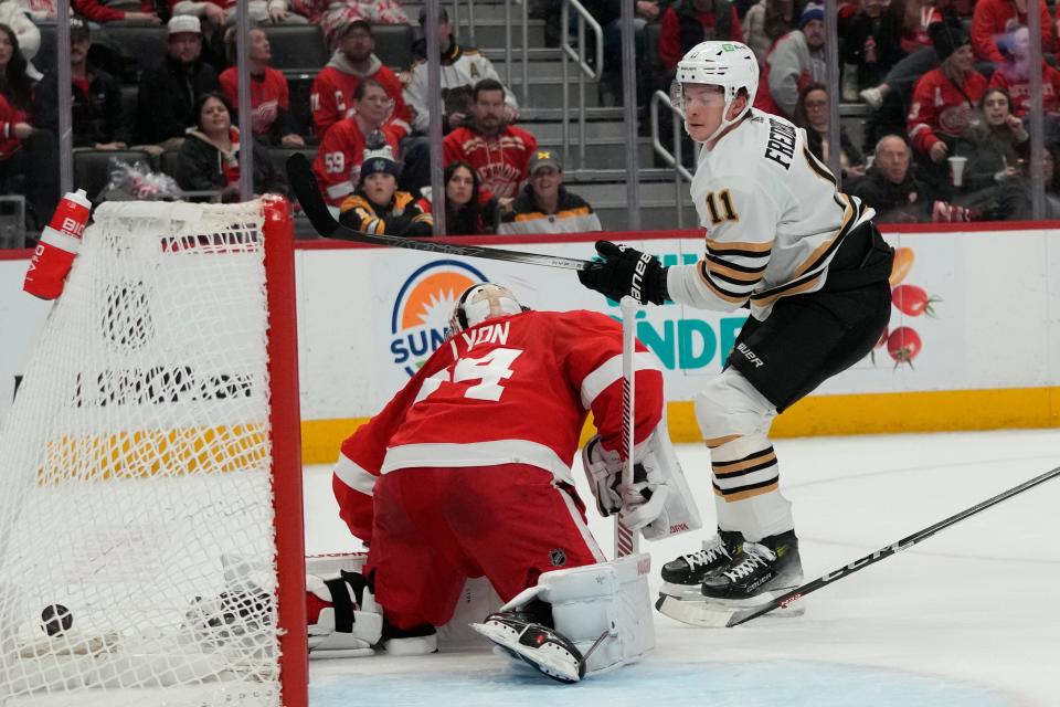 Boston Bruins center Trent Frederic (11) shoots the puck past Detroit Red Wings goalie Alex Lyon for a goal during the first period at Little Caesars Arena in Detroit on Sunday, Dec. 31, 2023.