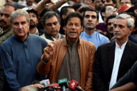 Pakistani opposition leader Imran Khan (C) talks to media outside his house in Islamabad, Pakistan, October 28, 2016. REUTERS/Stringer