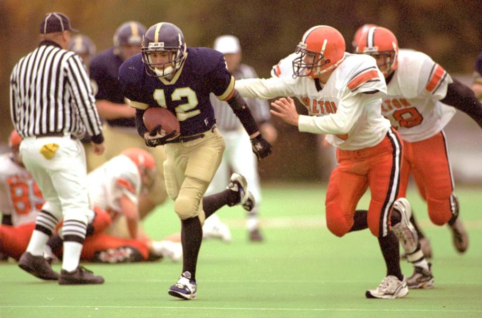 Elmira Notre Dame's Dave Noonan breaks away from Walton's Jason Budine on a 30-yard touchdown run during the 1998 Section 4 Class C title game at Cornell University won 21-20 by the Crusaders.