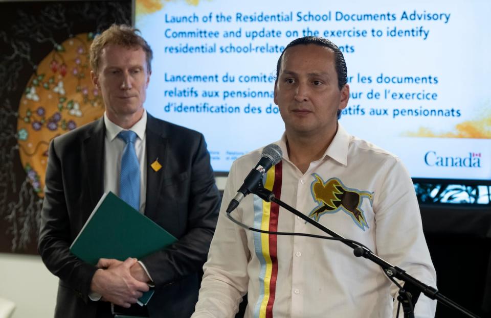 Crown-Indigenous Relations Minister Marc Miller looks on as chair of the Residential School Documents Advisory Committee Cadmus Delorme speaks during a news conference in Ottawa in June 2023.