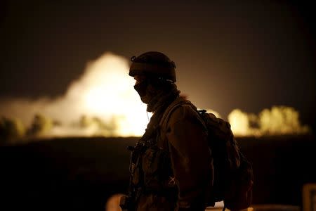 An Israeli soldier guards near the Jewish settlement of Otniel in the West Bank January 17, 2016, after a female resident of the settlement was stabbed to death in her home when an assailant broke into her house and attacked her, the Israeli army and a local settlement official said. REUTERS/Ronen Zvulun