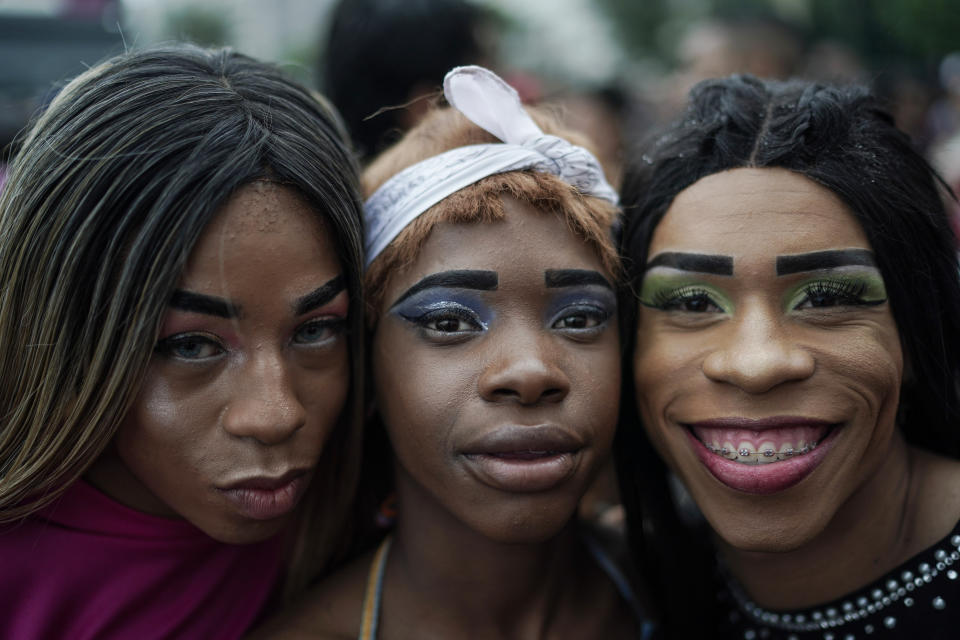Revelers pose for a picture during the annual gay pride parade along Copacabana beach in Rio de Janeiro, Brazil, Sunday, Sept. 22, 2019. The 24th gay pride parade titled this year's parade: "For democracy, freedom and rights, yesterday, today and forever." (AP Photo/Leo Correa)