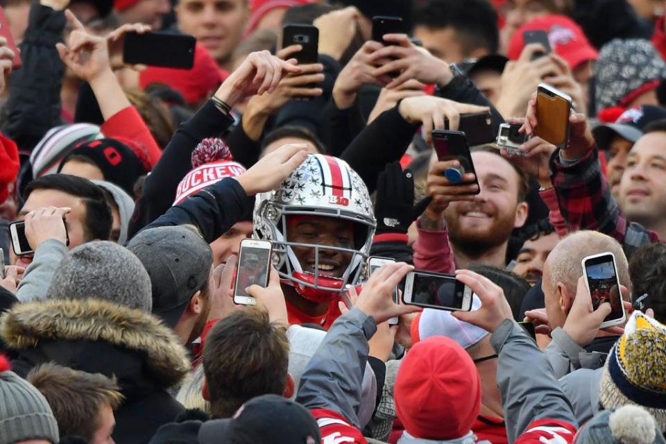 COLUMBUS, OH - NOVEMBER 24:  Quarterback Dwayne Haskins #7 of the Ohio State Buckeyes is congratulated by fans as he walks off the field after defeating the Michigan Wolverines at Ohio Stadium on November 24, 2018 in Columbus, Ohio. Ohio State defeated Michigan 62-39.  (Photo by Jamie Sabau/Getty Images)