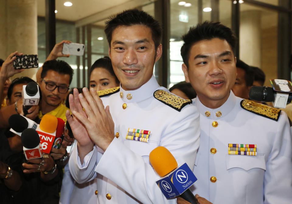 The leader of Thailand's Democrat Party Thanathorn Juangroongruangkit, center, and secretary-general Piyabutr Saengkanokkul, right, arrives at the parliament Bangkok, Thailand, Friday, May 24, 2019. Thailand’s King Maha Vajiralongkorn plans to officially open parliament following the first democratic election since a coup five years ago. (AP Photo/Sakchai Lalit)