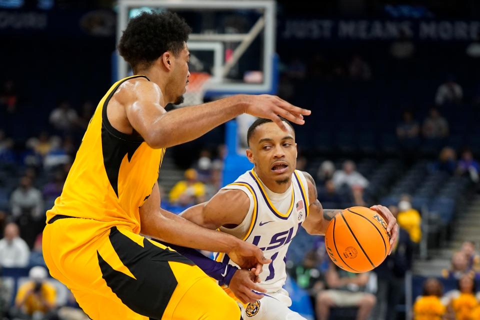 LSU guard Xavier Pinson, right, makes a move to get past Missouri forward Ronnie DeGray III during a game at the Southeastern Conference Tournament in Tampa, Fla.