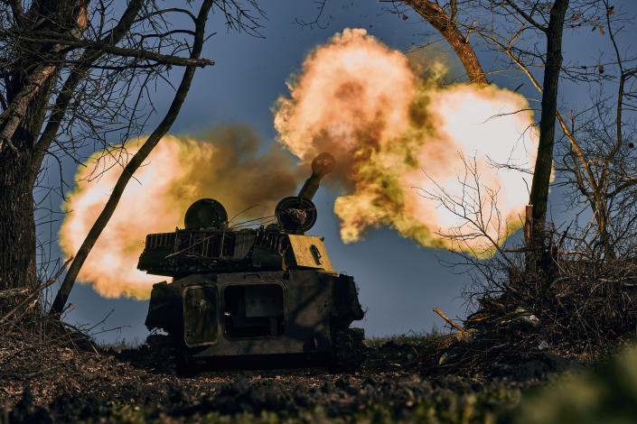 A self-propelled artillery vehicle fires near Bakhmut, Donetsk region, Ukraine, Wednesday, Nov. 9, 2022. (AP Photo/LIBKOS)