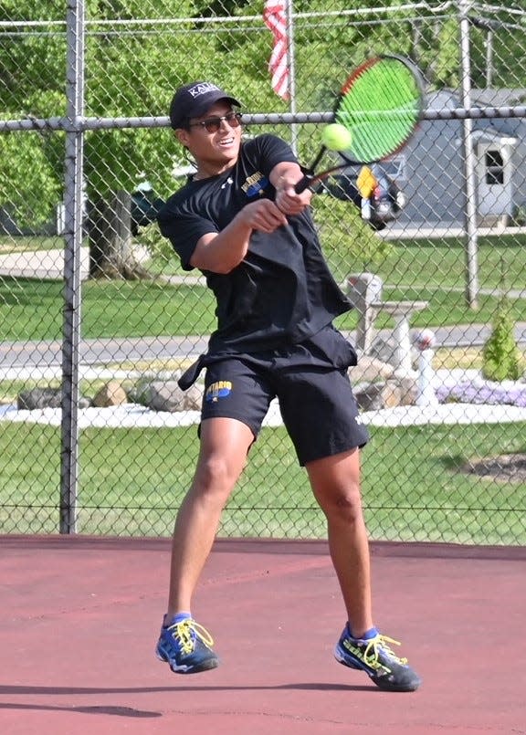 Ontario's Joseph Litao returns a serve during the district semifinal match with Lexington on Monday.