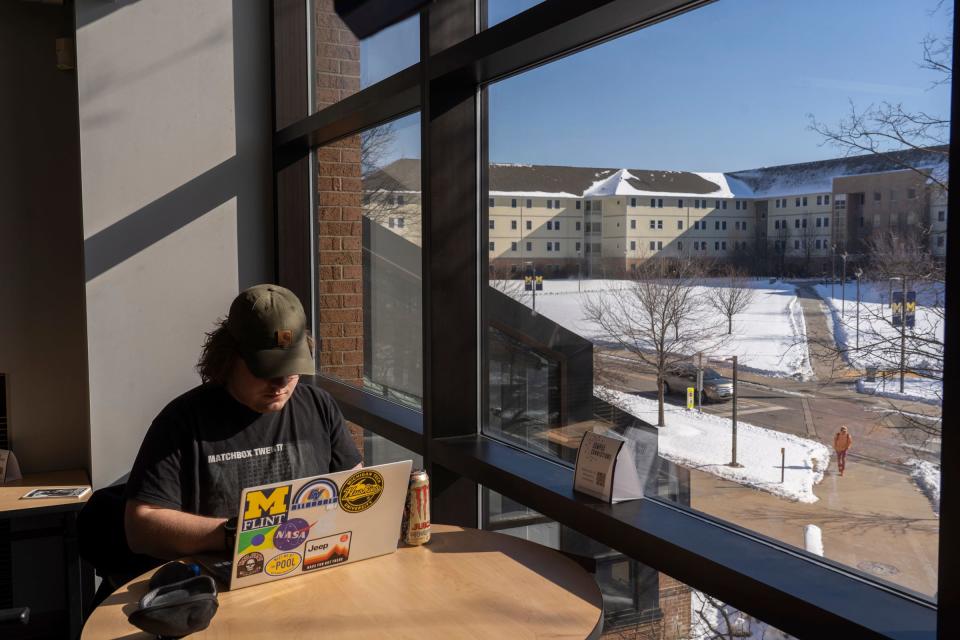U-M Flint student Eric Melen, of Swartz Creek, studies in a section of the Murchie Science Building as the First Street Residence Hall is seen through a window at the U-M Flint campus in downtown Flint on Wednesday, Feb. 1, 2023.