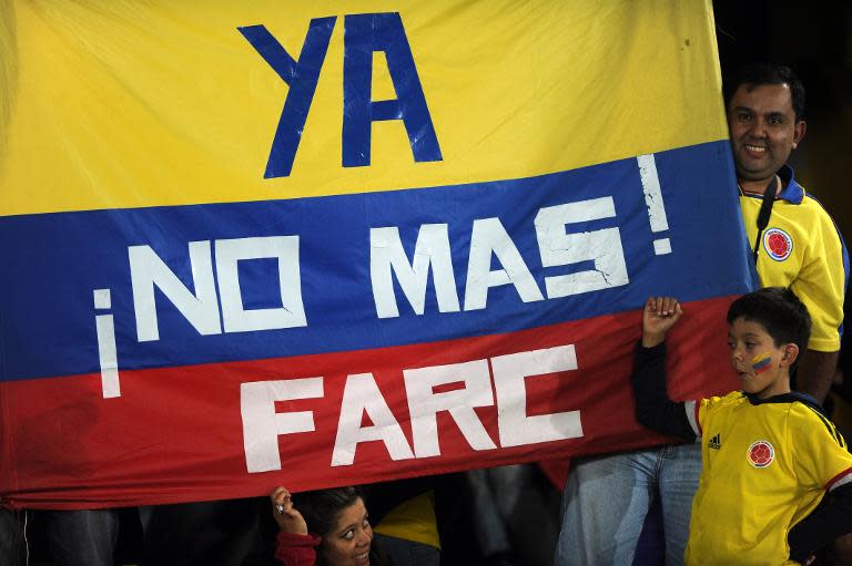 Colombian fans hold a national flag reading "No more FARC" before an Under-20 World Cup match against Costa Rica in Bogota, Colombia, on August 9, 2011