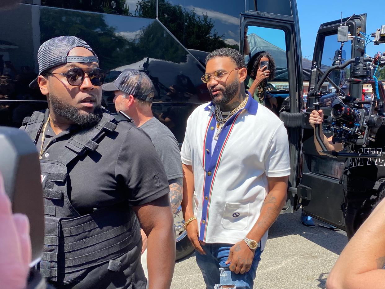 Joyner Lucas stepping off his bus, arriving to much fanfare from fans looking to be in his music video.