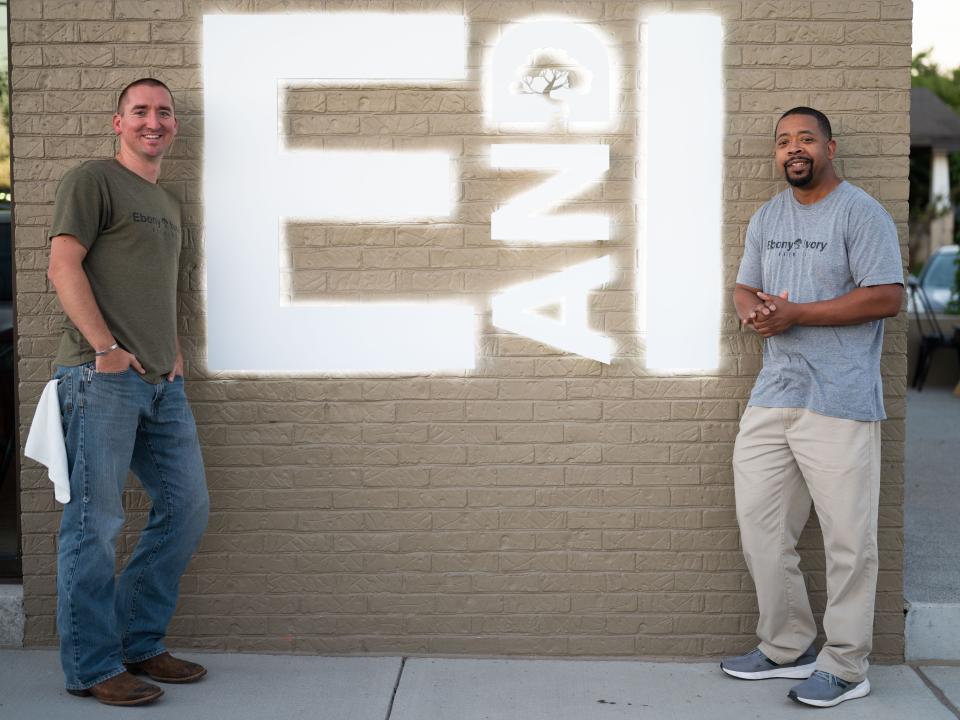 Ebony & Ivory co-owners Mitchell Russell and Chico Dupas pose in front of their company sign on 2300 North Central Street on Tuesday, Sept. 27, 2022